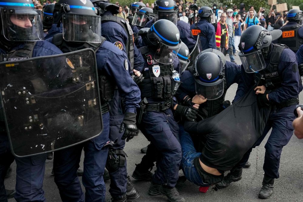 France suspends stun grenades at student protests after teen loses hand
